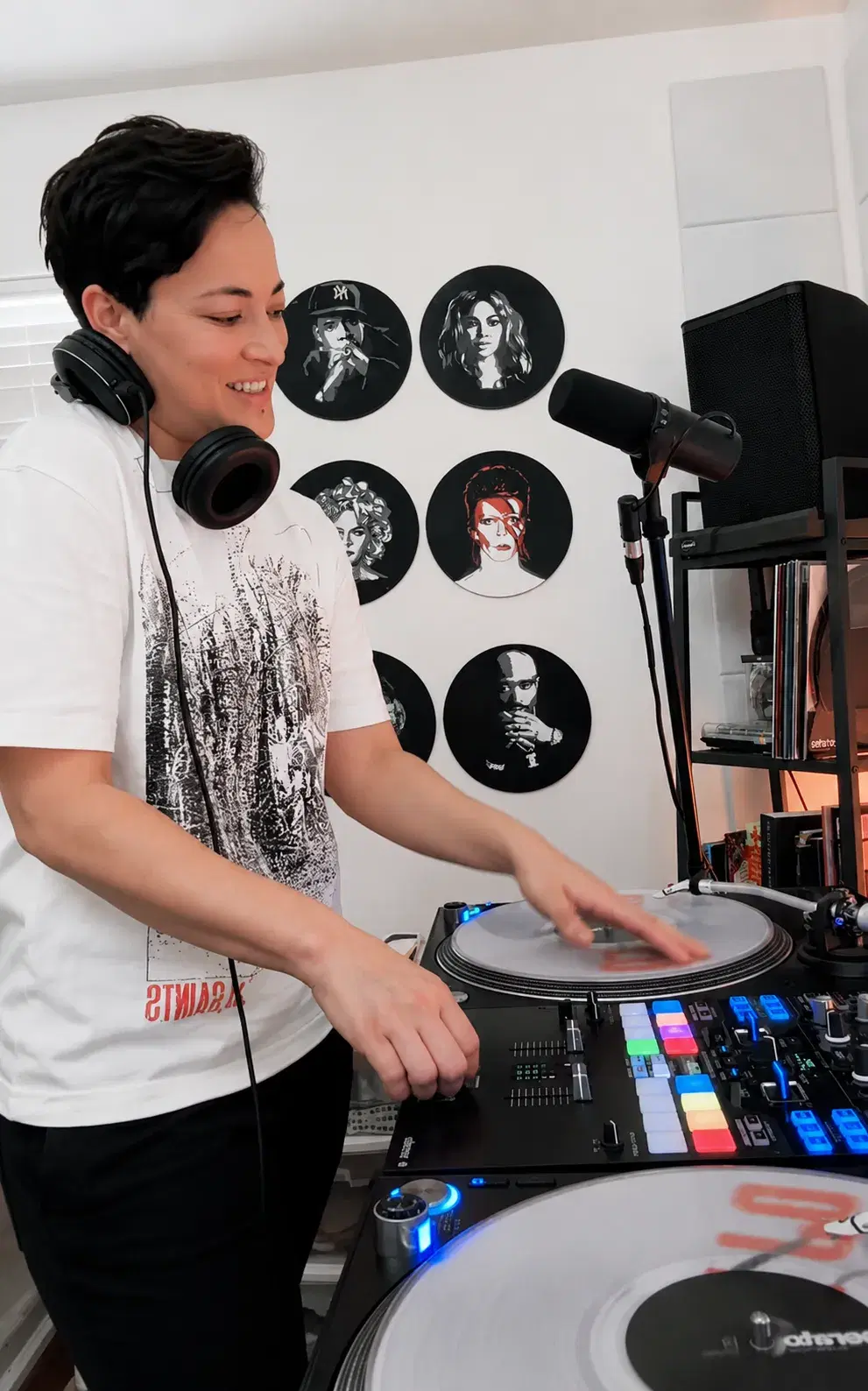 DJ Keelez scratching on turntables in her home studio during a live-streamed virtual event