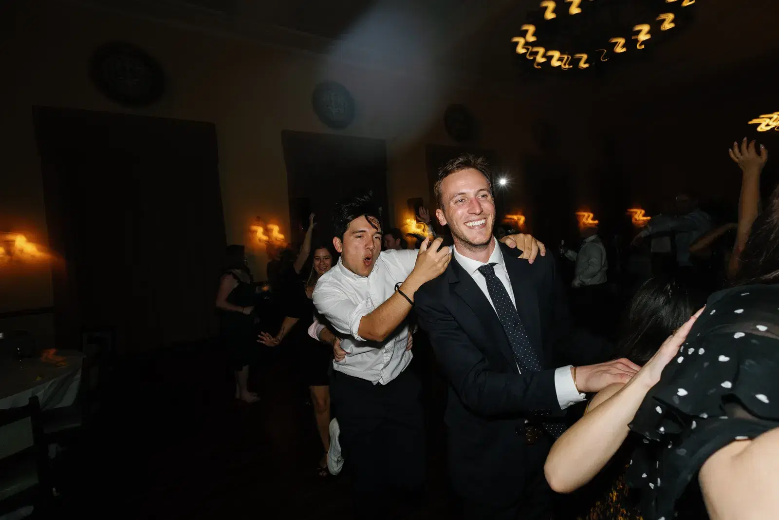 Two colleagues dancing and laughing together at a Southern California company celebration