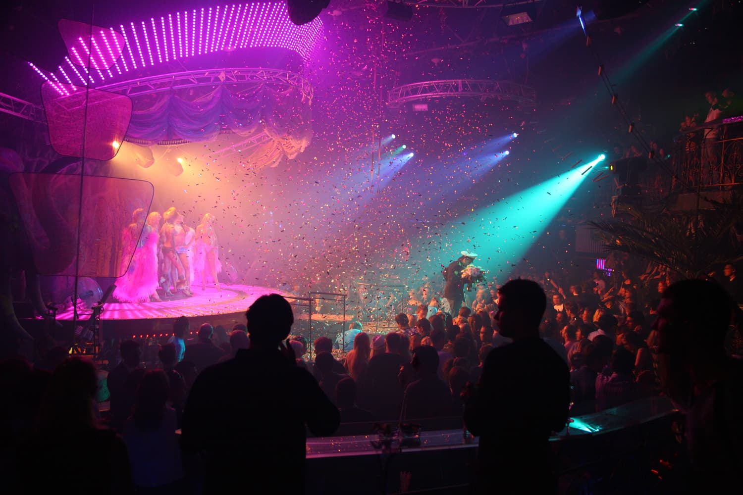 a small theatre event with pink and aqua lighting and confetti