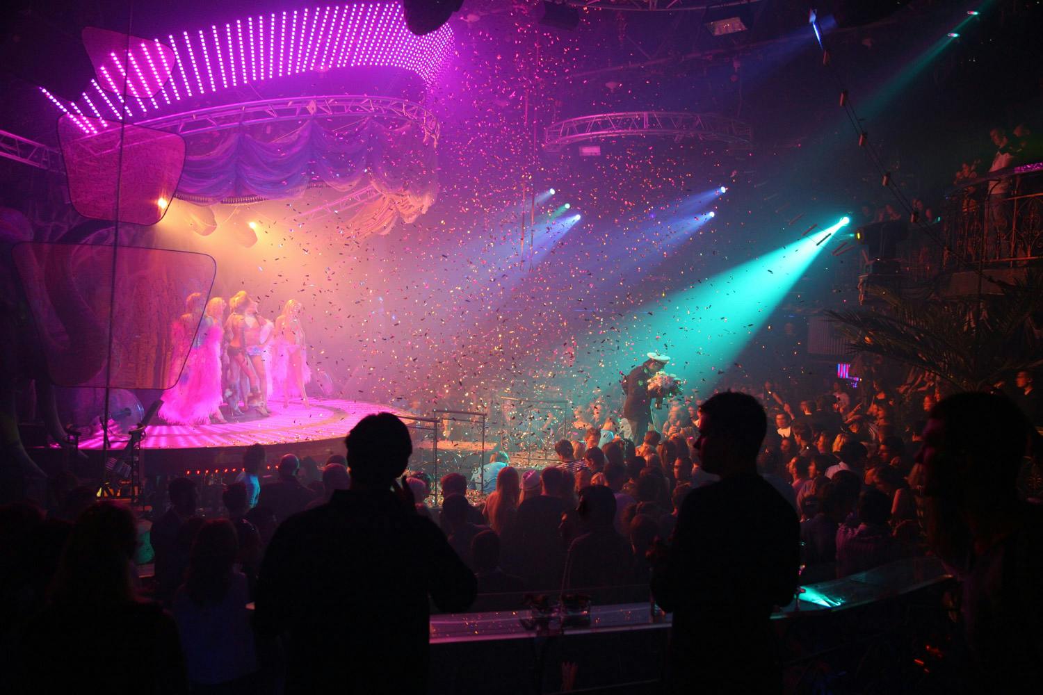 a small theatre event with pink and aqua lighting and confetti
